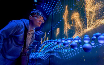 Guest immersed in a sensory video journey through Scotland with dynamic visuals.
