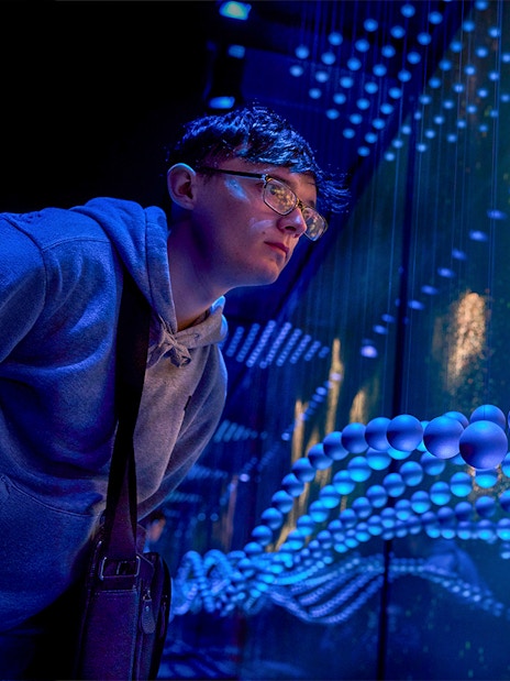 Guest immersed in a sensory video journey through Scotland with dynamic visuals.