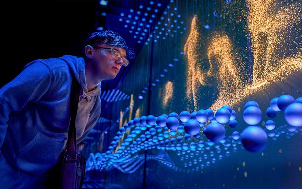 Guest immersed in a sensory video journey through Scotland with dynamic visuals.