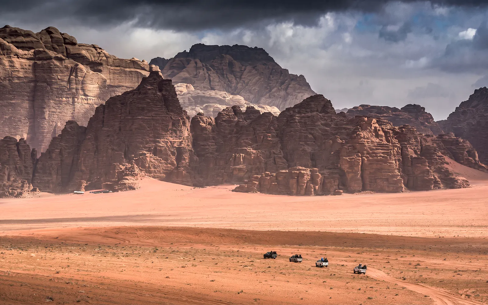 Jeep tour through Wadi Rum desert landscape with rocky formations, Jordan.
