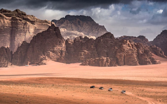 Jeep tour through Wadi Rum desert landscape with rocky formations, Jordan.