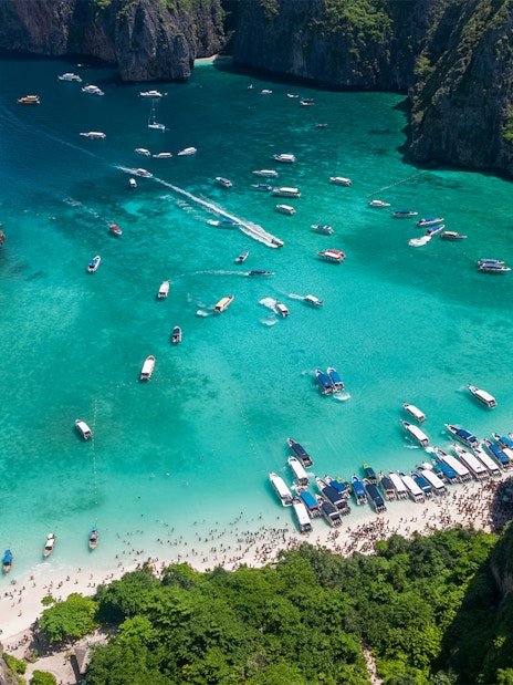 Aerial view of boats and tourists at Maya Bay, Phi Phi Island, Thailand.