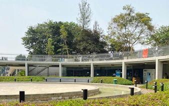 Jakarta MRT station entrance surrounded by greenery on a walking tour.