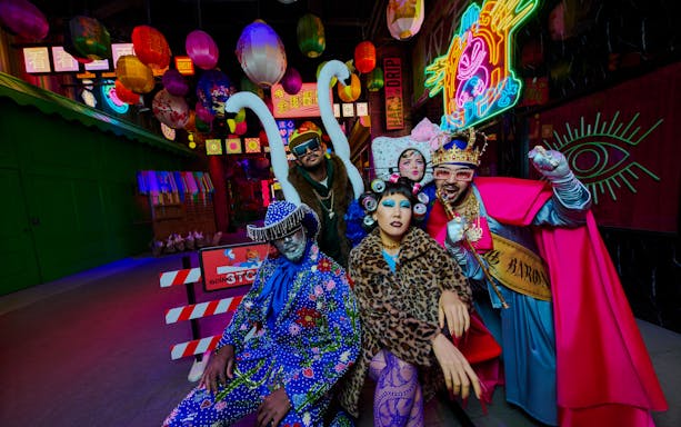 People in vibrant costumes at Enchanted Carnival, Halloween Experience, House of Hype.