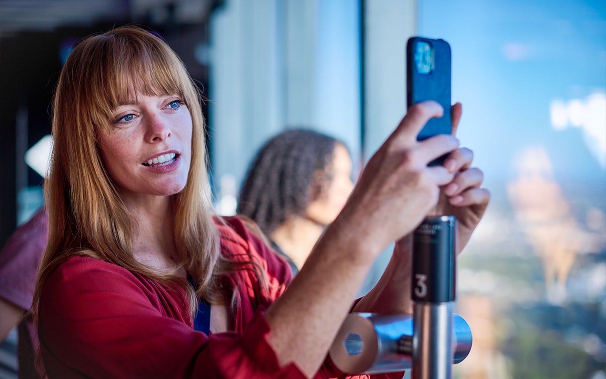 Woman photographing view at Melbourne Skydeck.