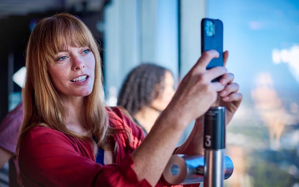 Woman photographing view at Melbourne Skydeck.