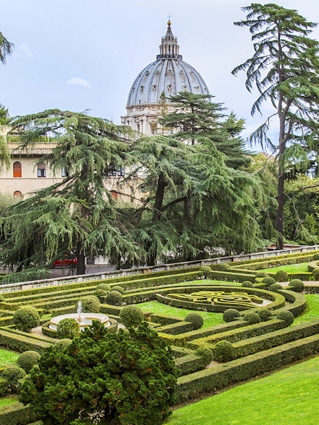 Vatican Gardens with St. Peter's Basilica dome in the background, Rome.