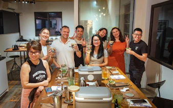 Group enjoying coffee-themed cocktails in a Vietnamese café setting.