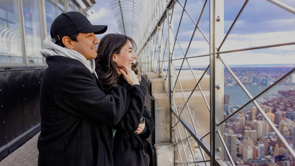 Guests enjoying the view from the Empire State Building observation deck in New York City.
