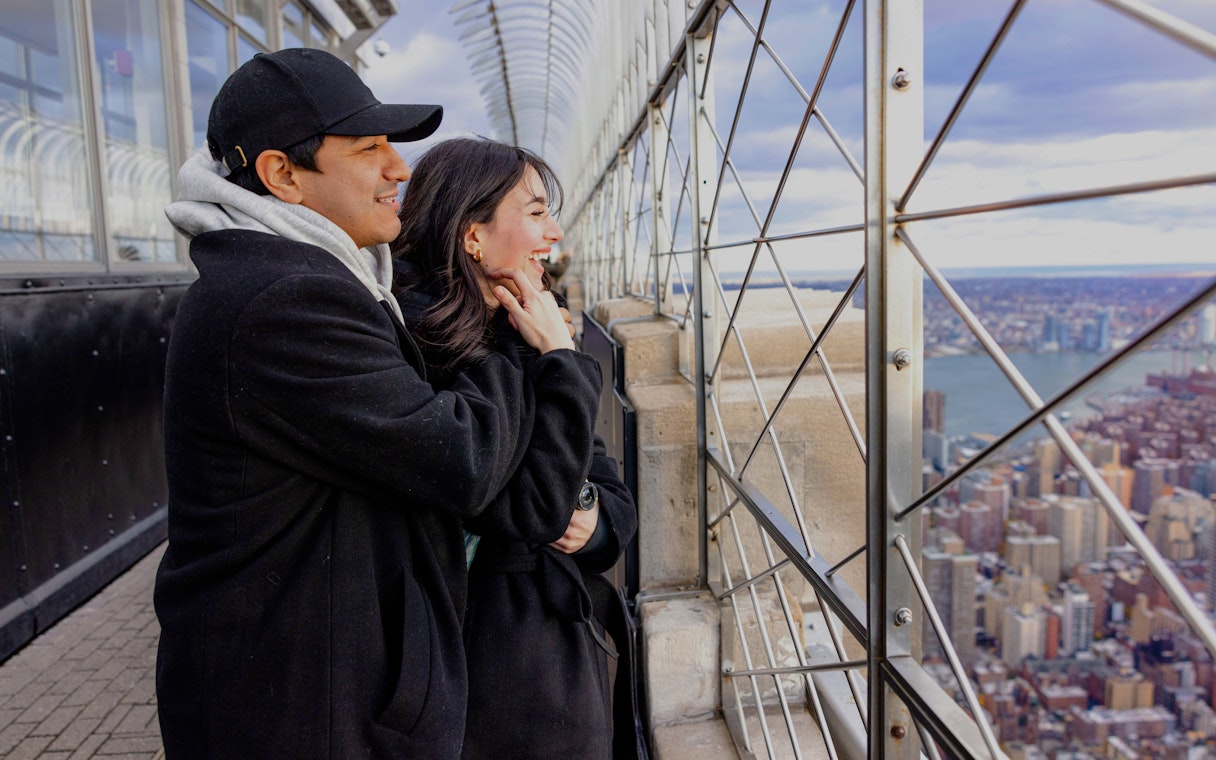 Guests enjoying the view from the Empire State Building observation deck in New York City.
