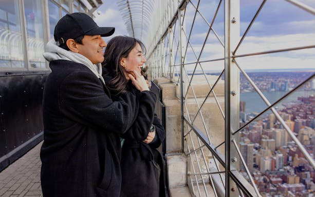 Guests enjoying the view from the Empire State Building observation deck in New York City.