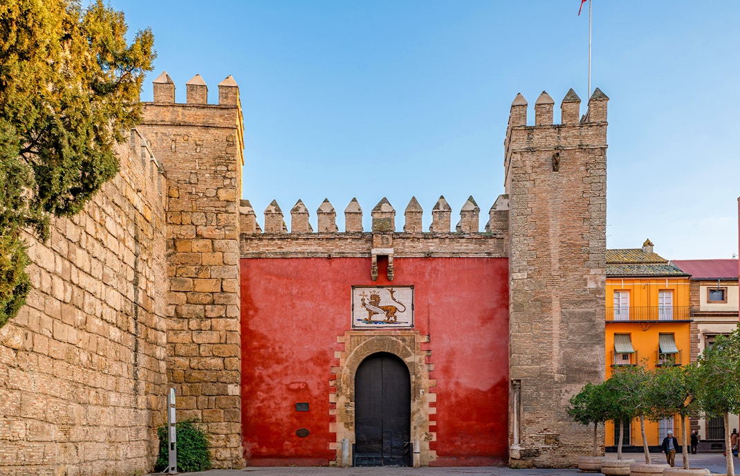 Puerta del León entrance at Alcazar of Seville, Spain, showcasing intricate architectural details.
