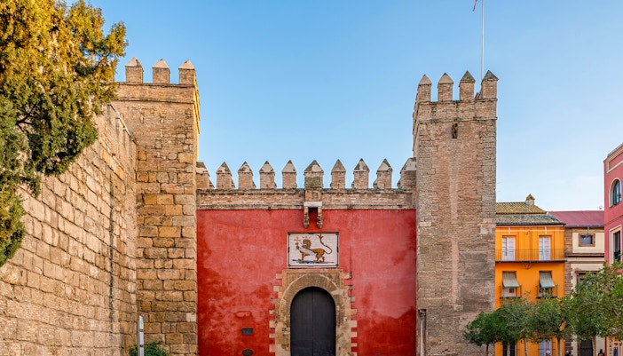 Puerta del León entrance at Alcazar of Seville, Spain, showcasing intricate architectural details.