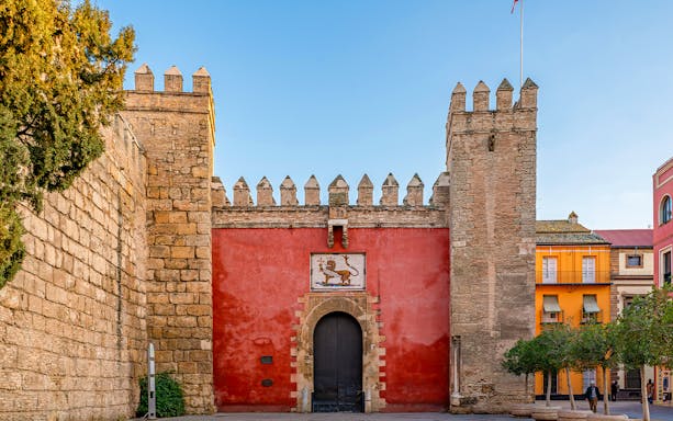 Puerta del León entrance at Alcazar of Seville, Spain, showcasing intricate architectural details.