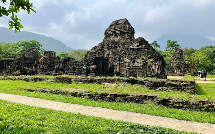 Hindu temple ruins at My Son Sanctuary, Vietnam, surrounded by lush greenery.