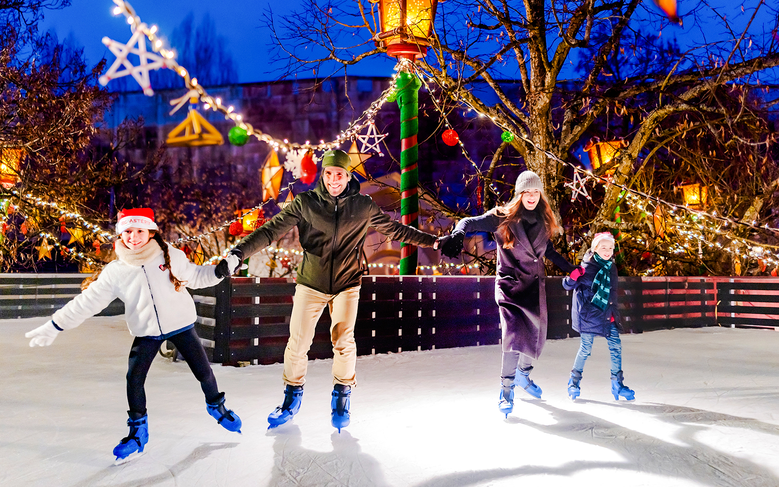 Family ice skating at Parc Asterix during Christmas celebrations.