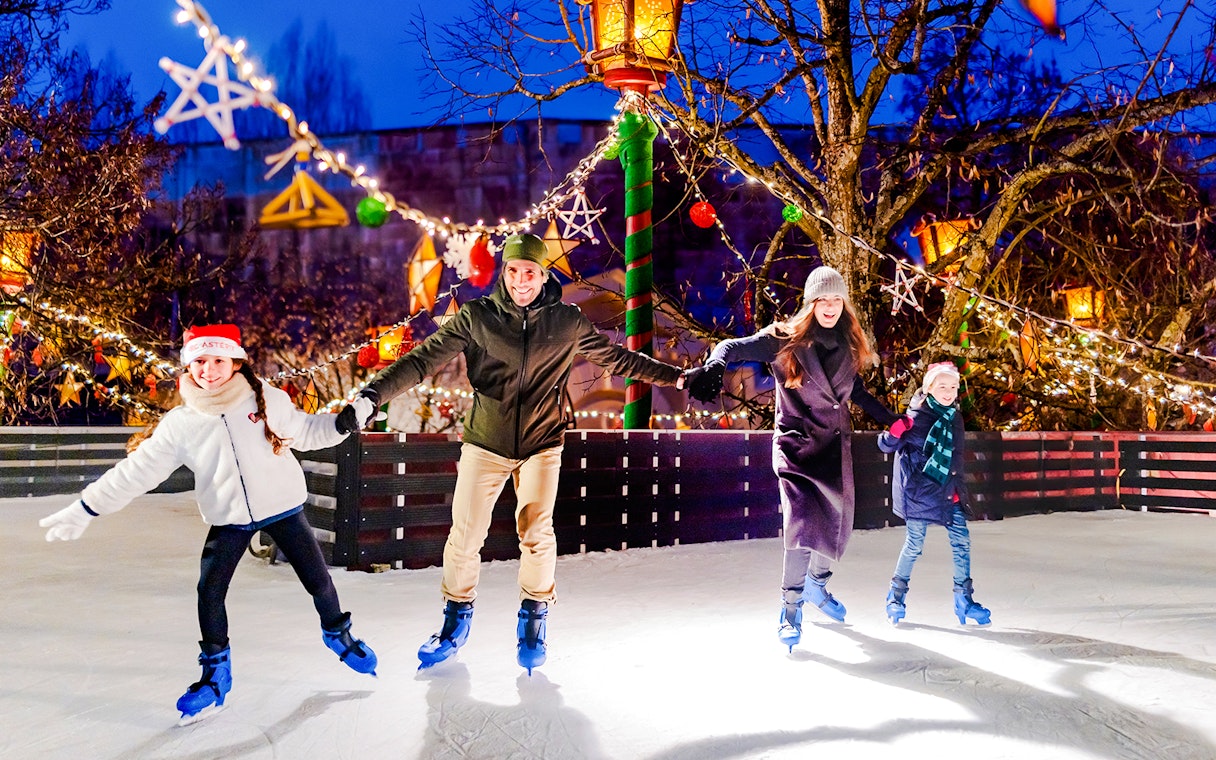 Family ice skating at Parc Asterix during Christmas celebrations.