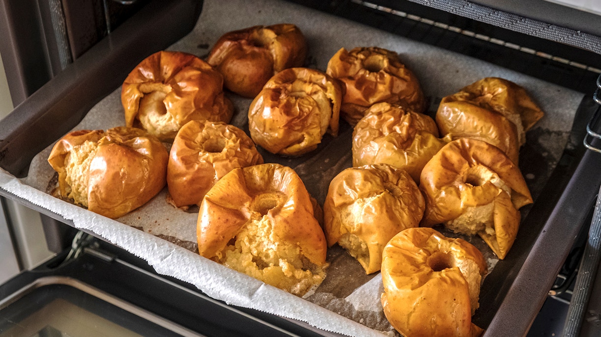 Mallorca dessert assortment with almond cake and ensaimada pastry on a wooden table.
