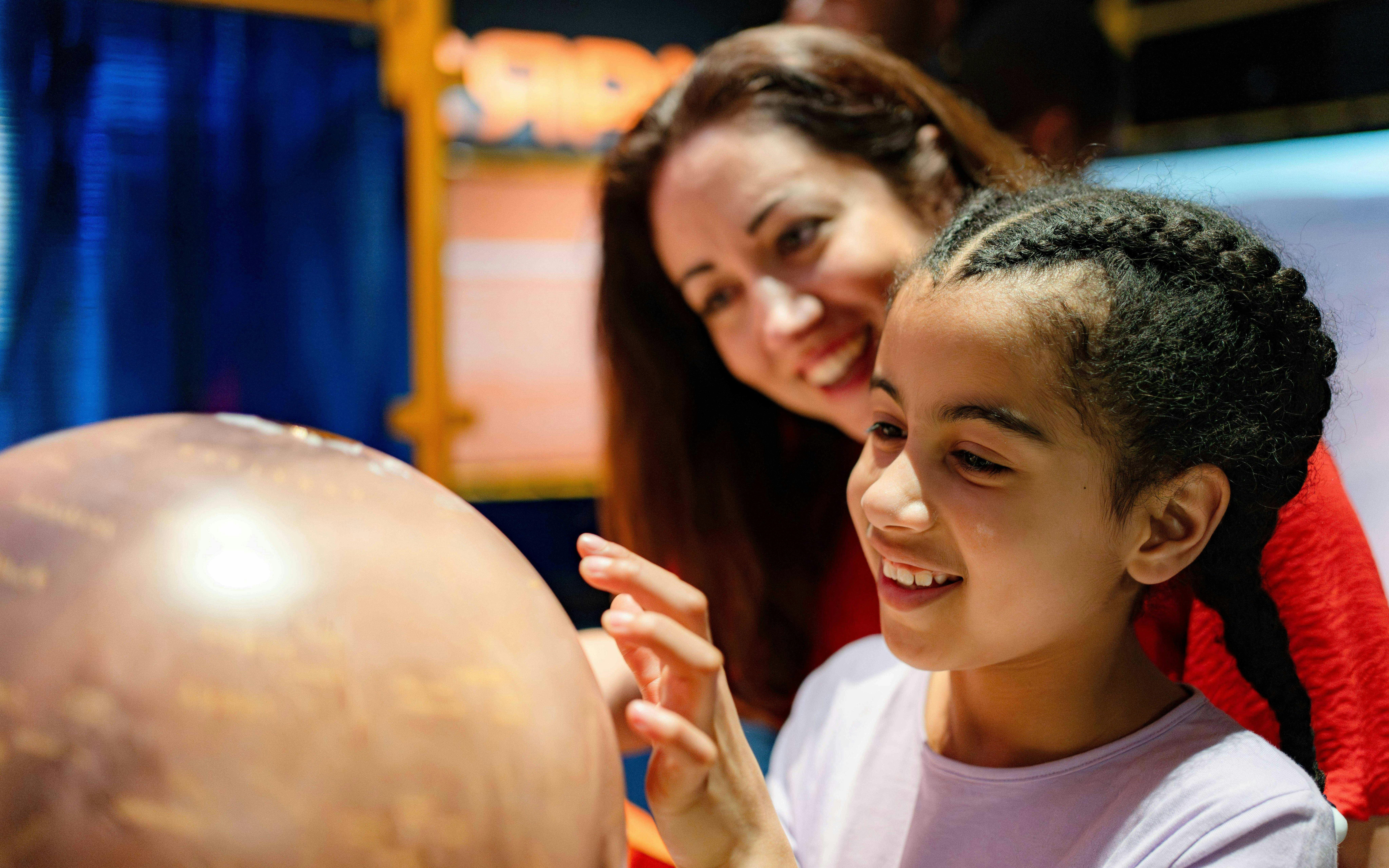 Guests exploring a globe at the Astronomers Take Over event, National Maritime Museum.
