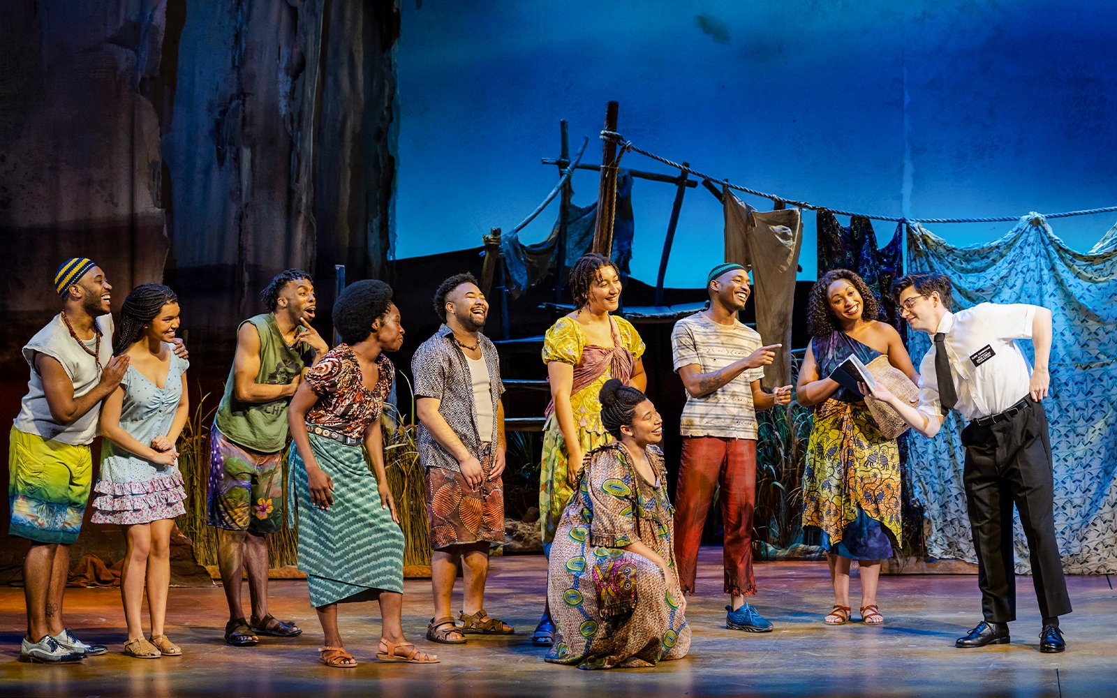 Stage performance of The Book of Mormon in Brisbane with actors in colorful costumes.