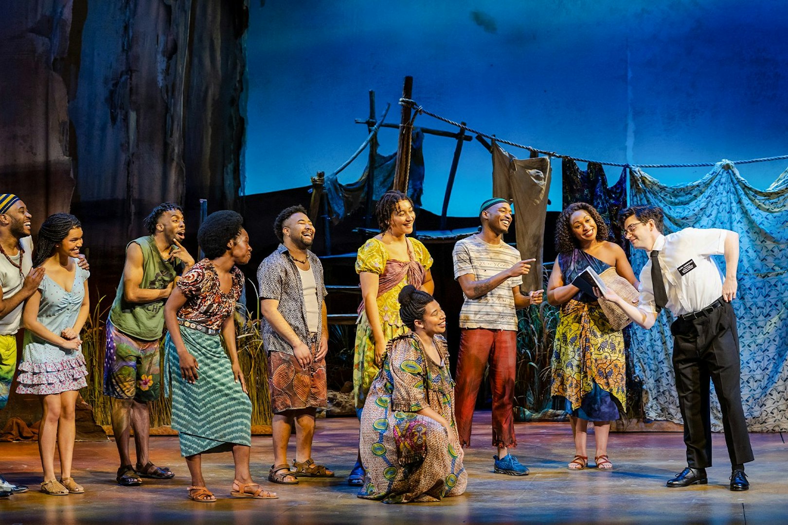 Stage performance of The Book of Mormon in Brisbane with actors in colorful costumes.