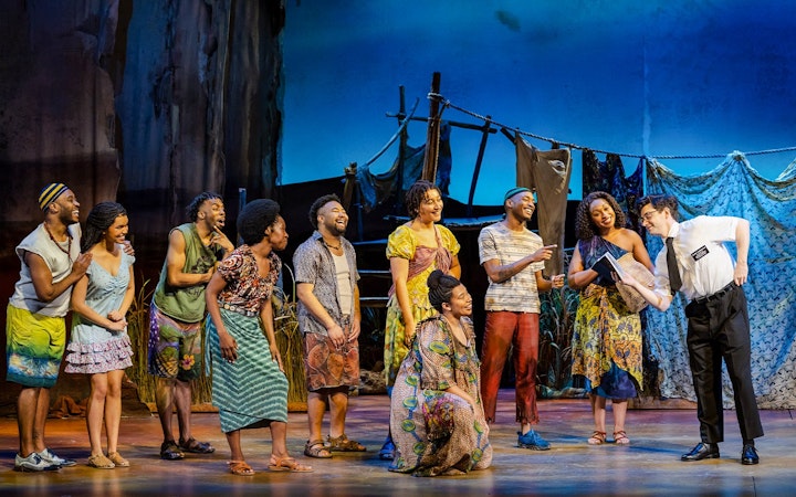 Stage performance of The Book of Mormon in Brisbane with actors in colorful costumes.