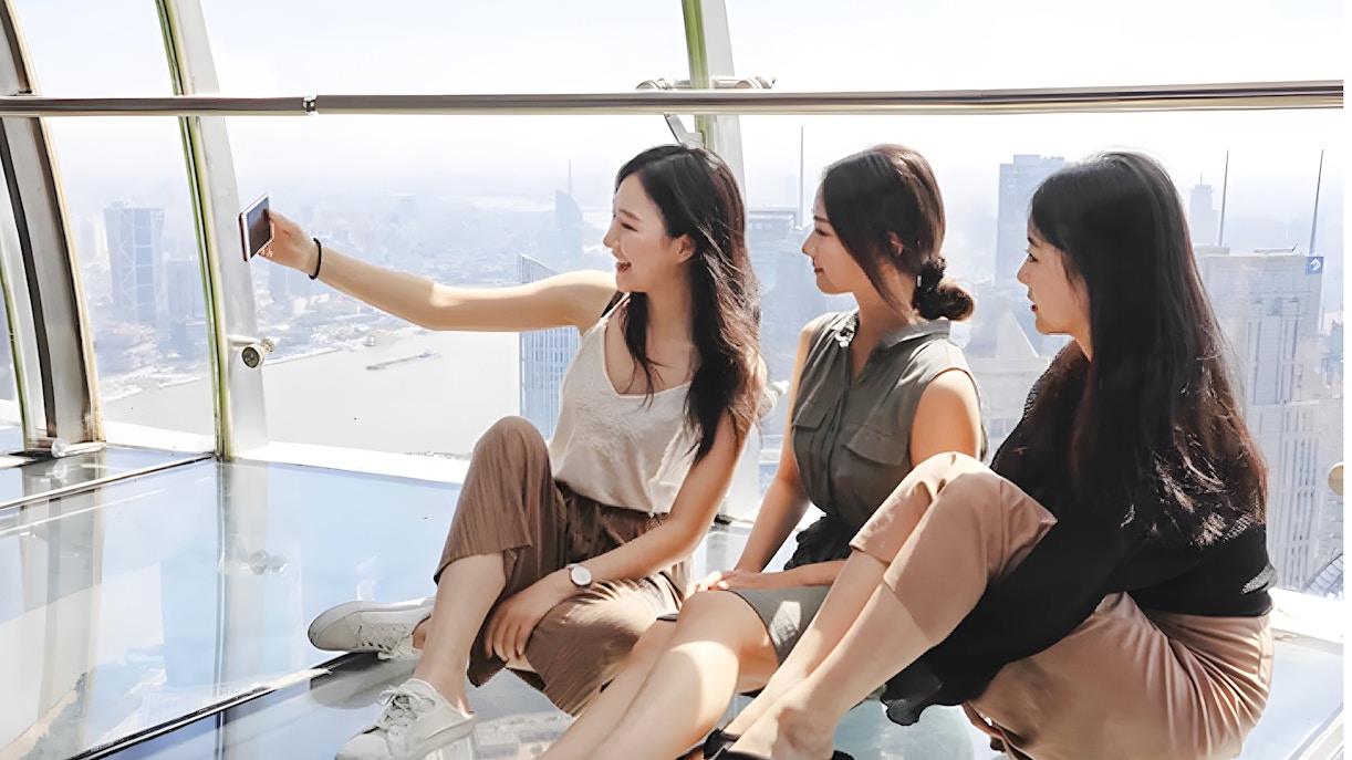 Women taking a selfie on the observation deck at Oriental Pearl Tower, Shanghai.