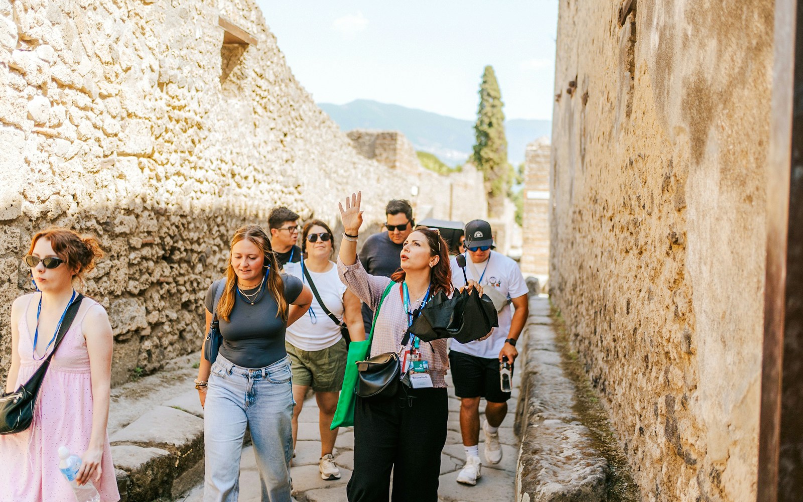 Tour group exploring ancient streets on a guided tour in Pompeii.