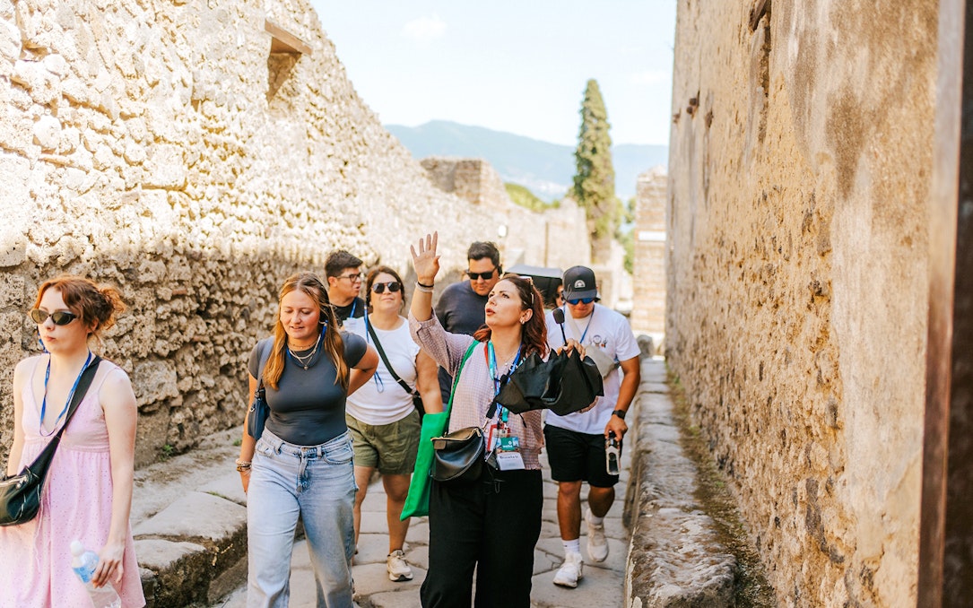 Tour group exploring ancient streets on a guided tour in Pompeii.