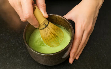 Whisking matcha in a bowl during a tea ceremony in Kyoto.