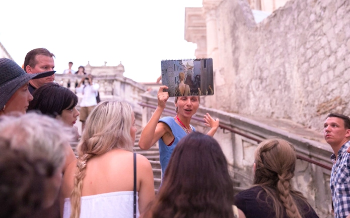 Tour guide showing Game of Thrones filming location in Dubrovnik to a group.