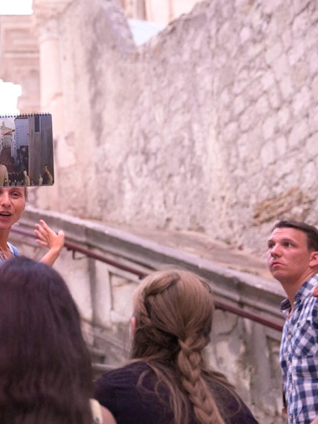 Tour guide showing Game of Thrones filming location in Dubrovnik to a group.