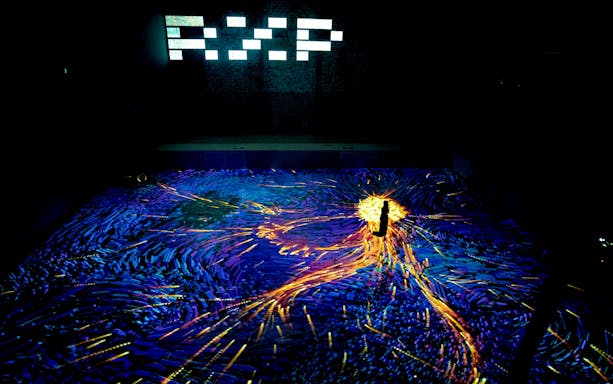 Immersive digital art display at Other World Art Gallery, REXKL, with vibrant lights and patterns.