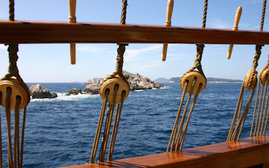 View of rocky islets from a ship deck during Dubrovnik Republic cruise.