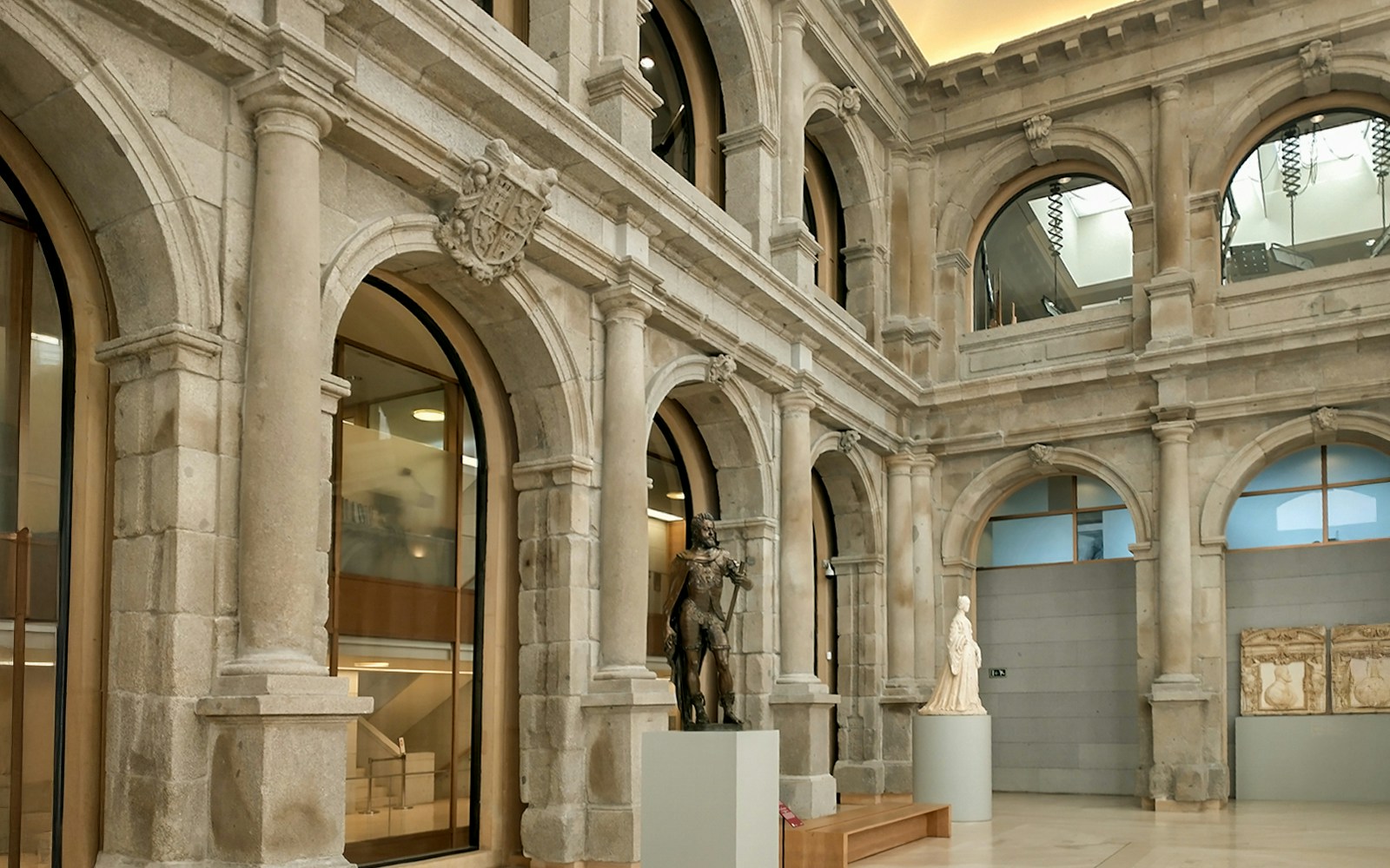 Jerónimos courtyard with statues and arches in Prado Museum, Madrid.