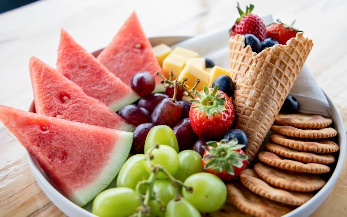 Fruit and cheese platter with watermelon, grapes, strawberries, and crackers on Phillip Island cruise.