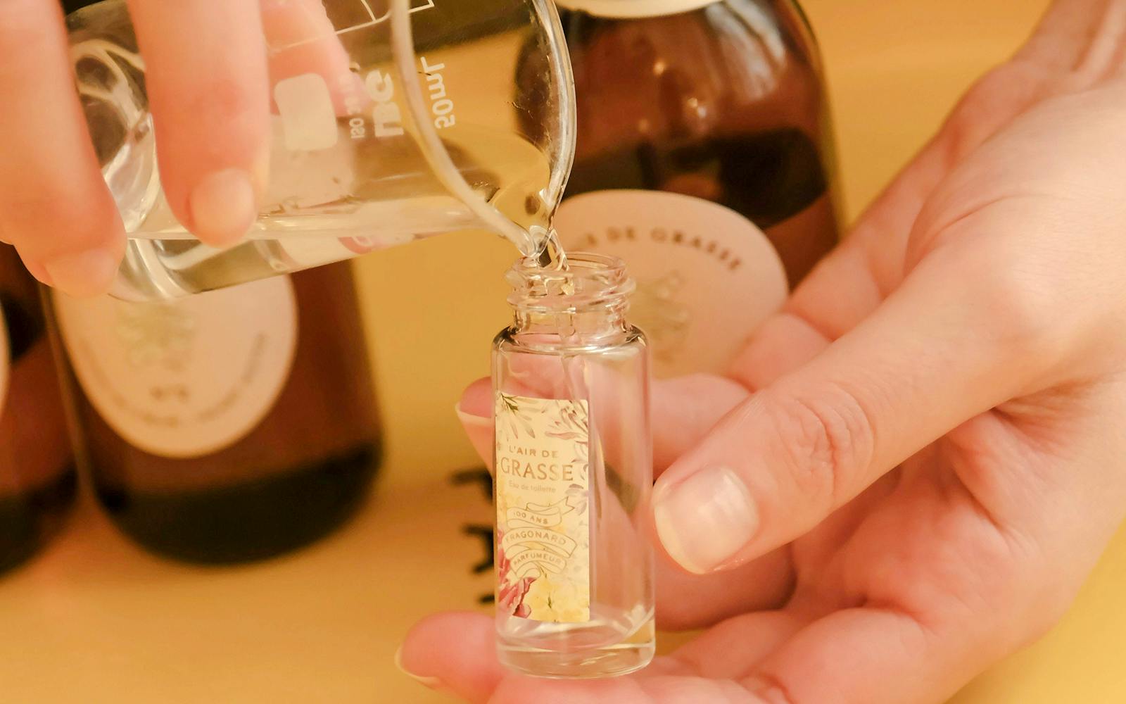 Perfume being poured into a Fragonard bottle during Opéra Garnier visit.