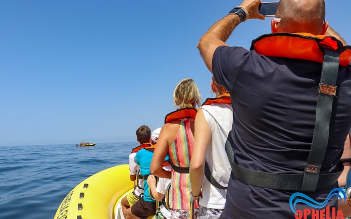 Tourists on a boat wearing life jackets, heading towards Benagil Caves for dolphin discovery.