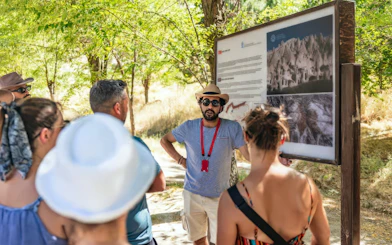 Tourists listening to a guide at Zelve Open Air Museum, Cappadocia.