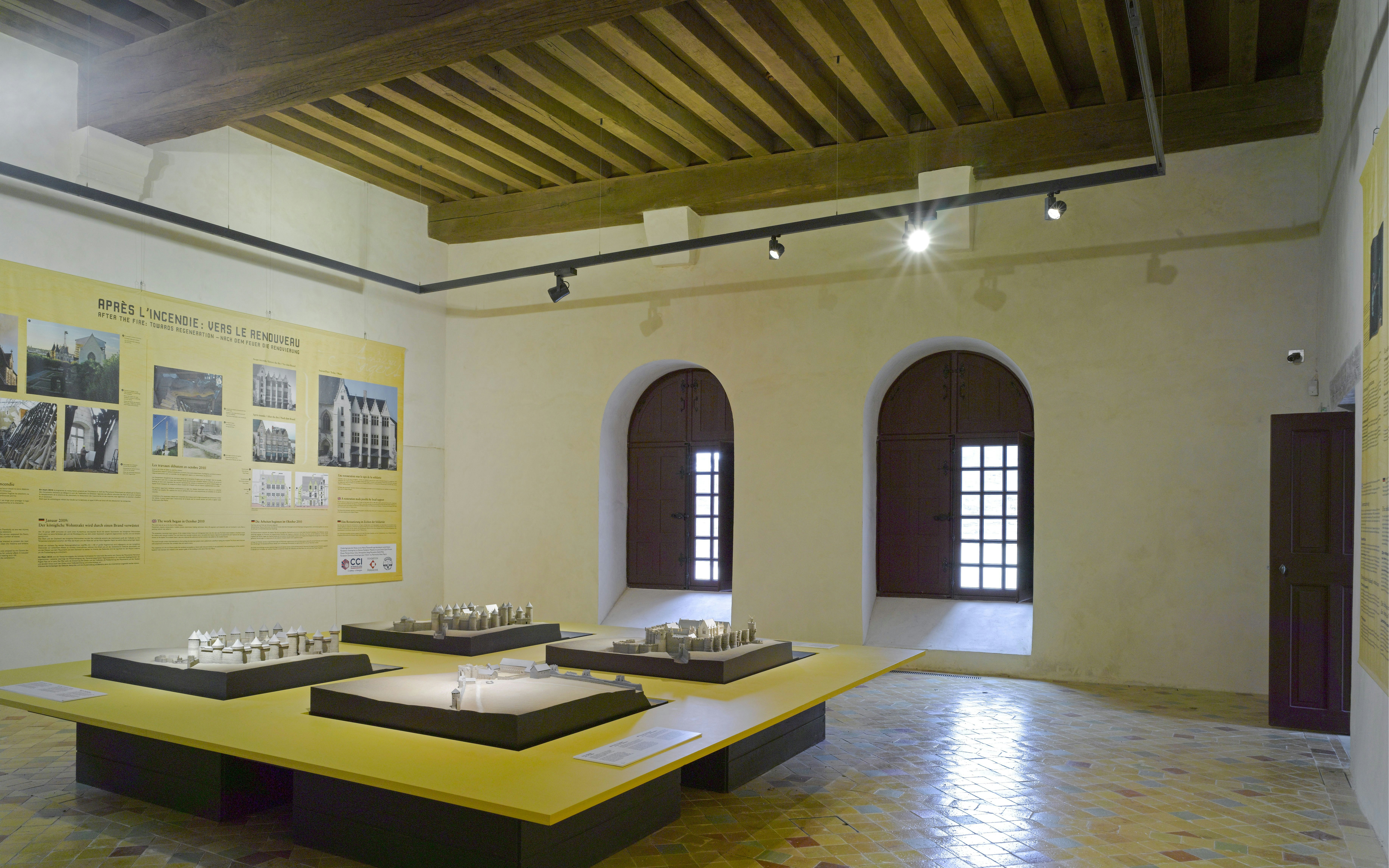 Château d’Angers exhibit room with architectural models and historical displays.