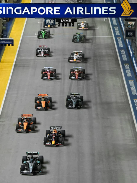 Racing cars lined up at the start of the Formula 1 Singapore Grand Prix night race.