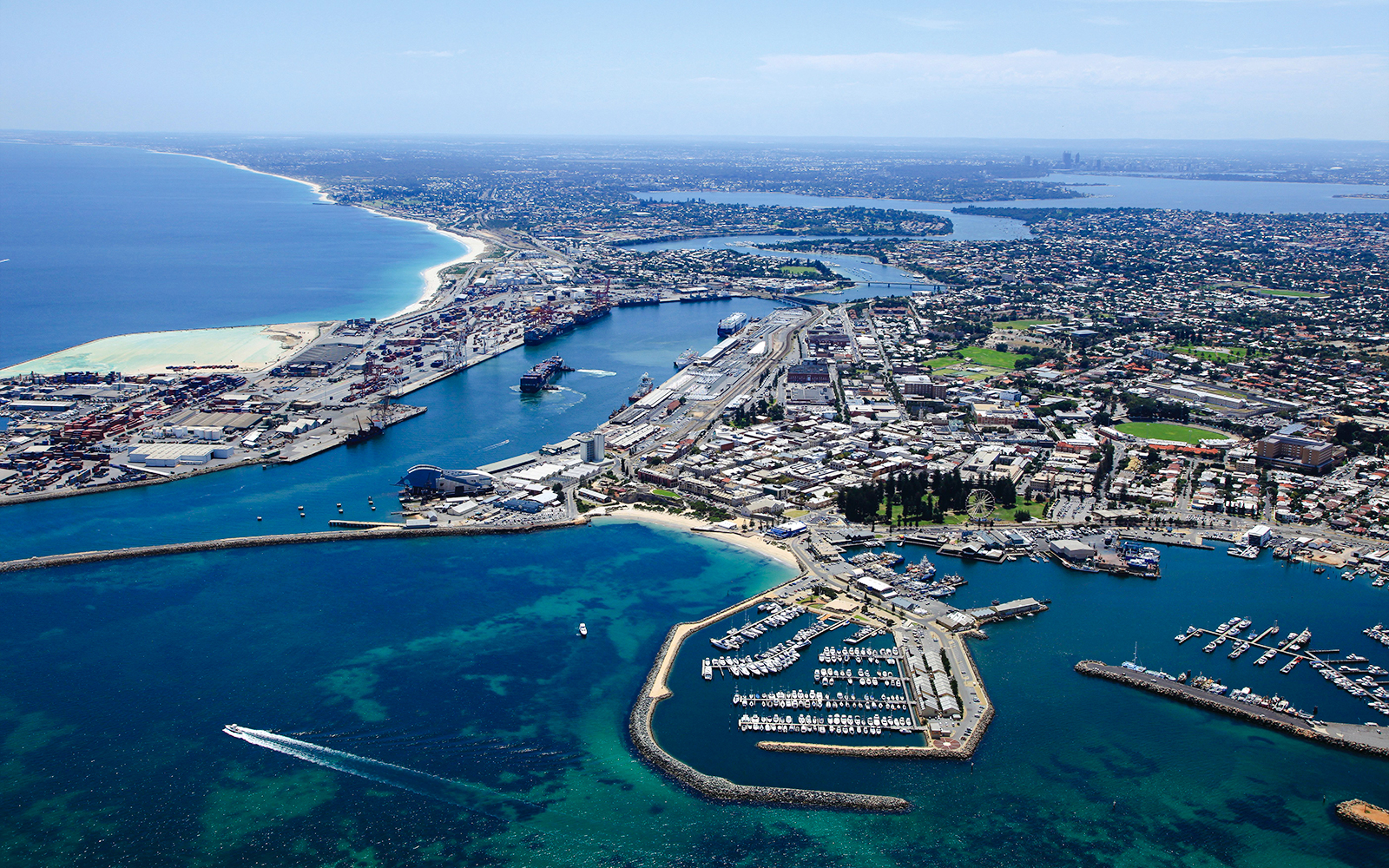 Aerial view of Fremantle Port and marina with surrounding cityscape.