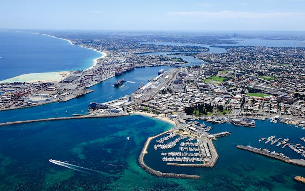 Aerial view of Fremantle Port and marina with surrounding cityscape.