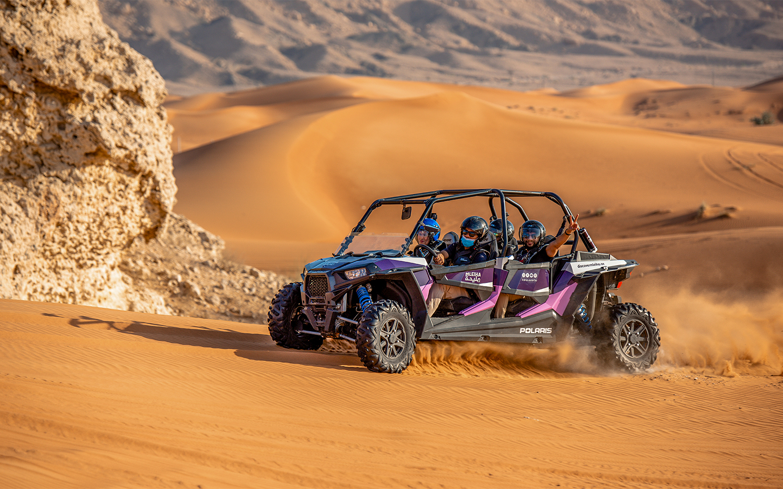 Dune buggy driving through Mleiha desert near Camel Rock.