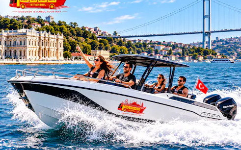 Speedboat on Bosphorus with Dolmabahçe Palace and bridge in Istanbul.