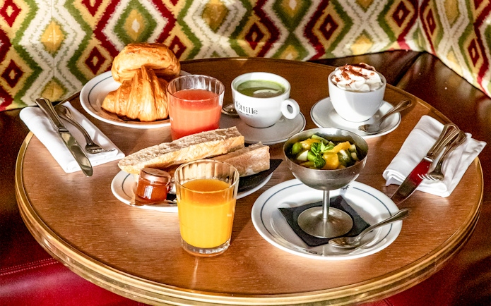 Flottille's breakfast spread with croissants, juice, coffee, and fruit salad.