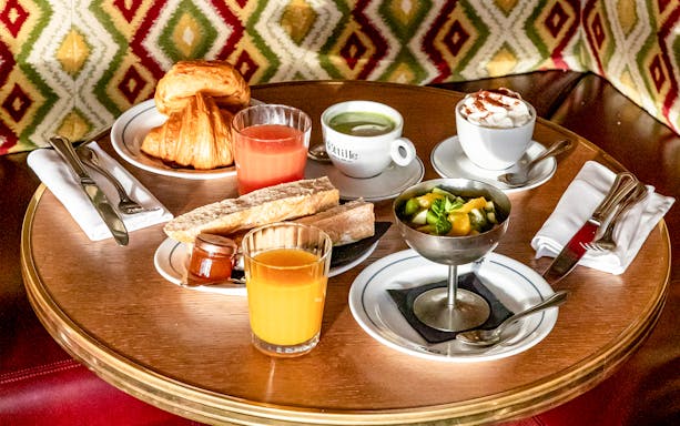 Flottille's breakfast spread with croissants, juice, coffee, and fruit salad.