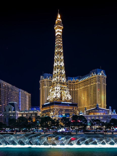 Eiffel Tower replica and fountain show at night, Las Vegas Strip.