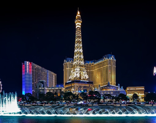 Eiffel Tower replica and fountain show at night, Las Vegas Strip.