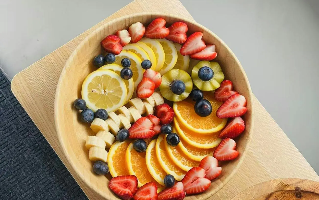 Fresh fruit platter with strawberries, blueberries, lemon, banana, and orange slices for Hobart sightseeing cruise.